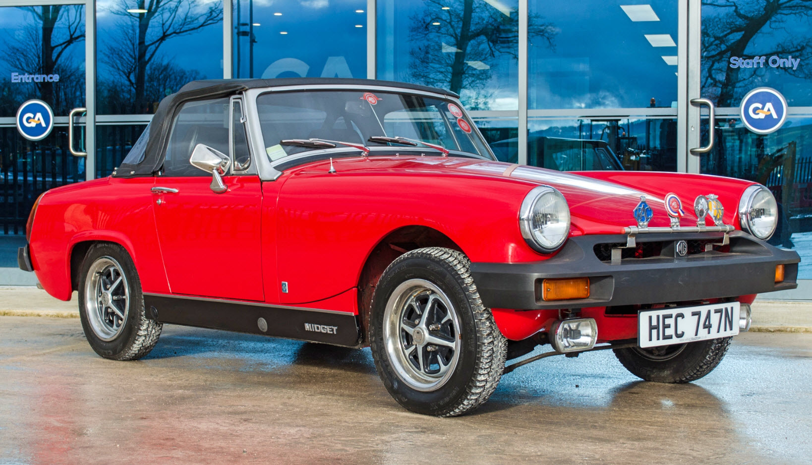 A 1975 MG Midget convertible car